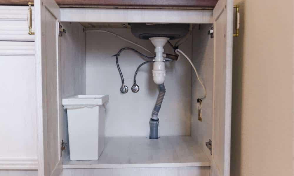 Remove Everything From Under The Sink For Repair The Stopper In A Bathroom Sink
